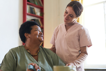 Elderly woman talking to caregiver